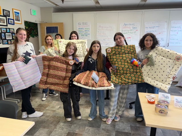 Rational Animal volunteers holding handmade animal beds